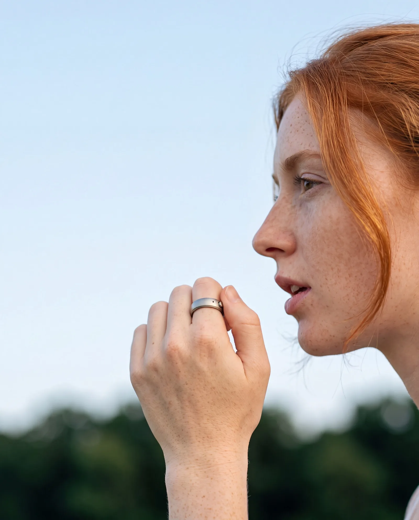 Person speaking naturally with hand slightly raised, wearing the interface ring