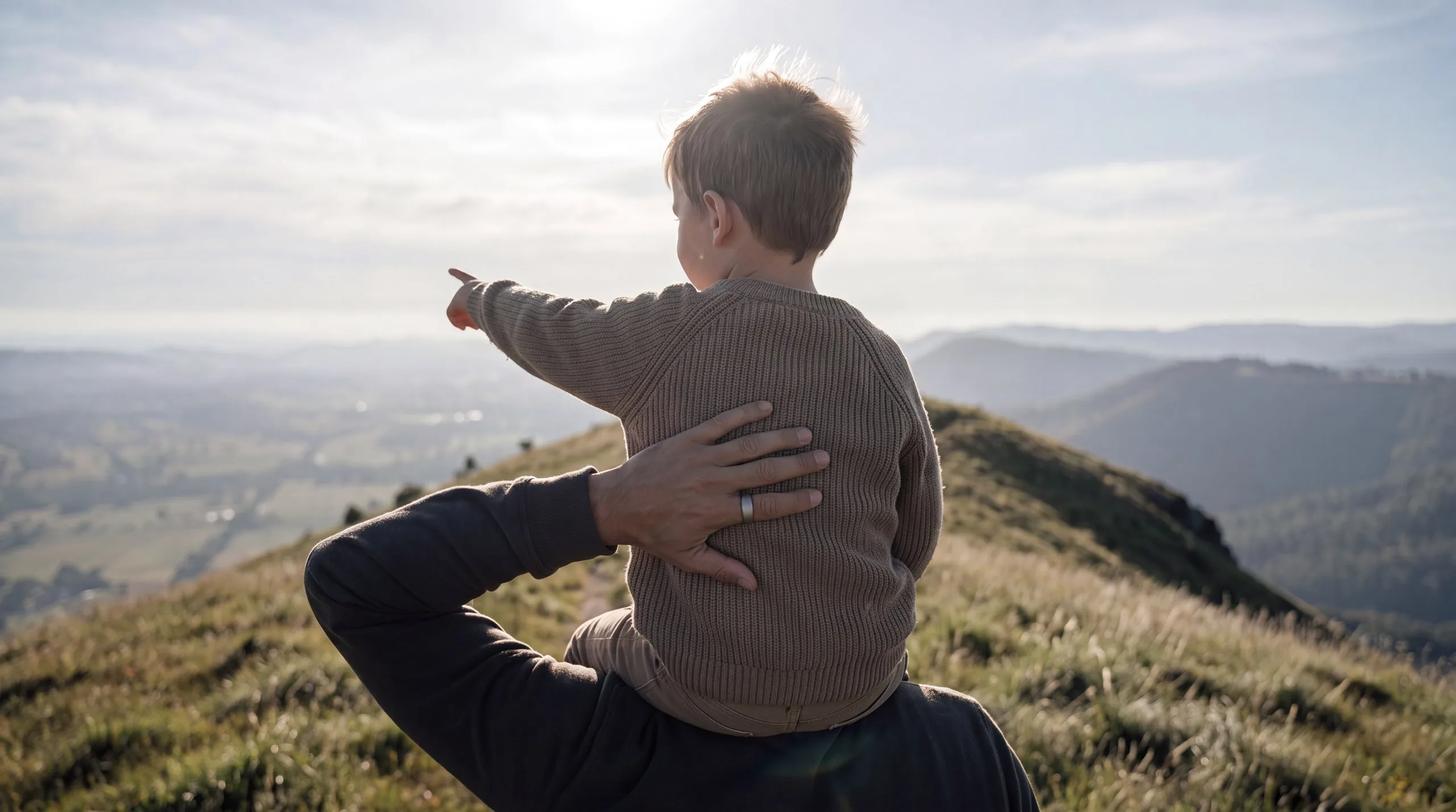 Person outdoors in clear natural light, the ring worn on the index finger, no phone anywhere